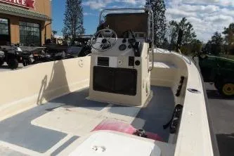 Slide: The Image of 1994 Key West 1720 Sportsman boat with outboard motor, parked on a trailer. - 5