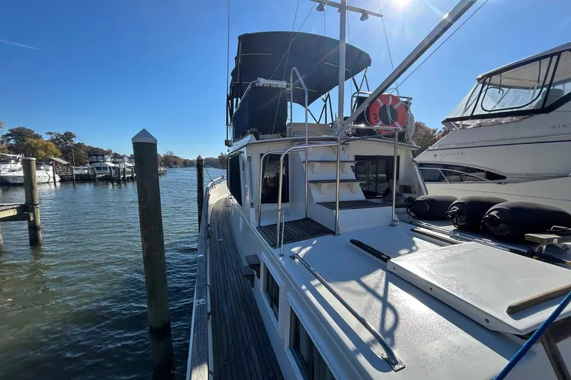 Slide: The Image of 1986 Grand Banks 42 Classic yacht docked in a sunny marina. - 10