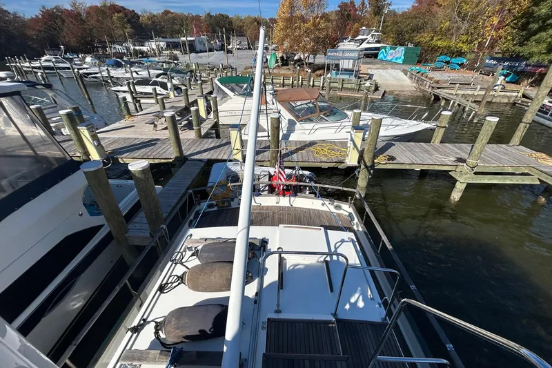Slide: The Image of 1986 Grand Banks 42 Classic yacht docked at a marina with surrounding boats. - 11