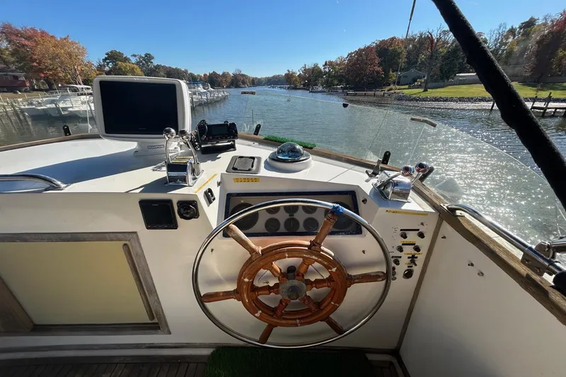 Slide: The Image of Helm of 1986 Grand Banks 42 Classic yacht with wooden steering wheel and navigation equipment. - 17