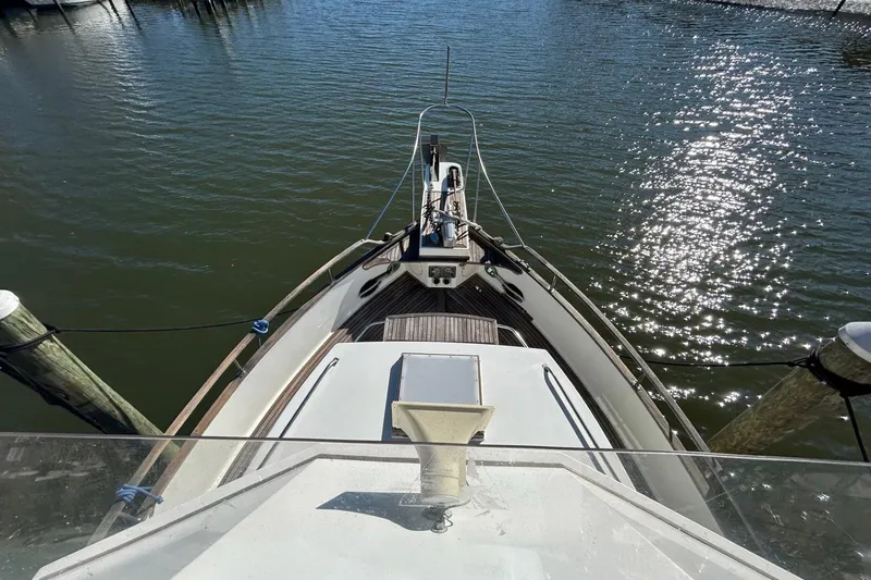 Slide: The Image of 1986 Grand Banks 42 Classic yacht bow view, docked on calm water. - 18