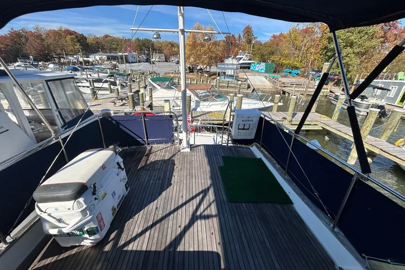 Slide: The Image of 1986 Grand Banks 42 Classic yacht deck at marina, surrounded by autumn trees and boats. - 19