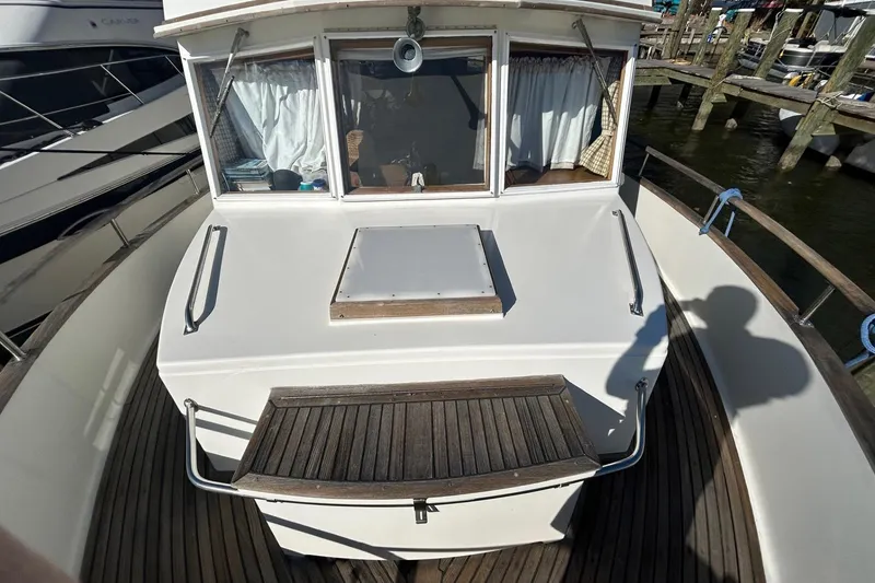Slide: The Image of 1986 Grand Banks 42 Classic yacht deck with wooden accents and docked at marina. - 20