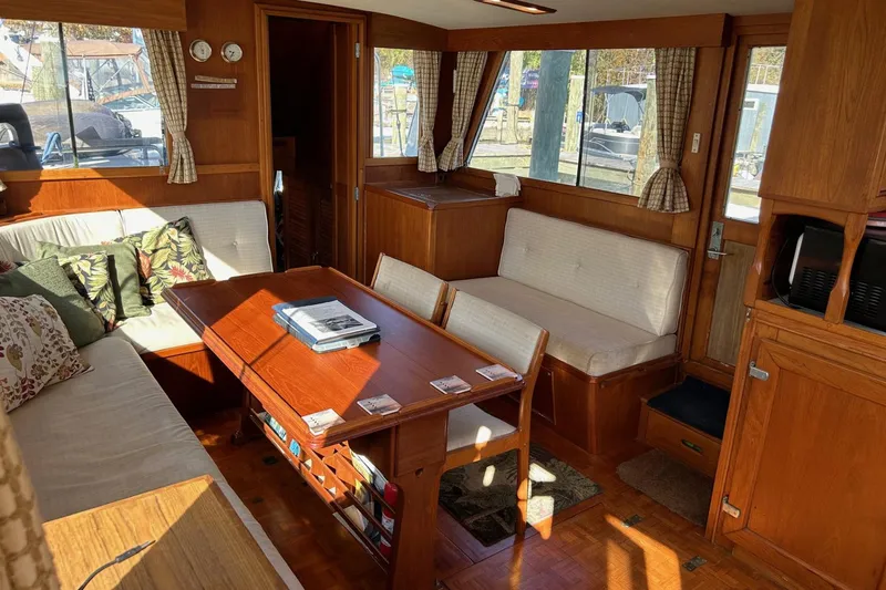 Slide: The Image of Interior of 1986 Grand Banks 42 Classic yacht with wooden furnishings and cozy seating. - 25