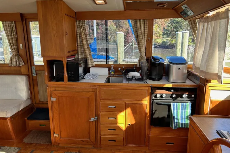 Slide: The Image of Interior of 1986 Grand Banks 42 Classic yacht kitchen with wooden cabinetry and appliances. - 26