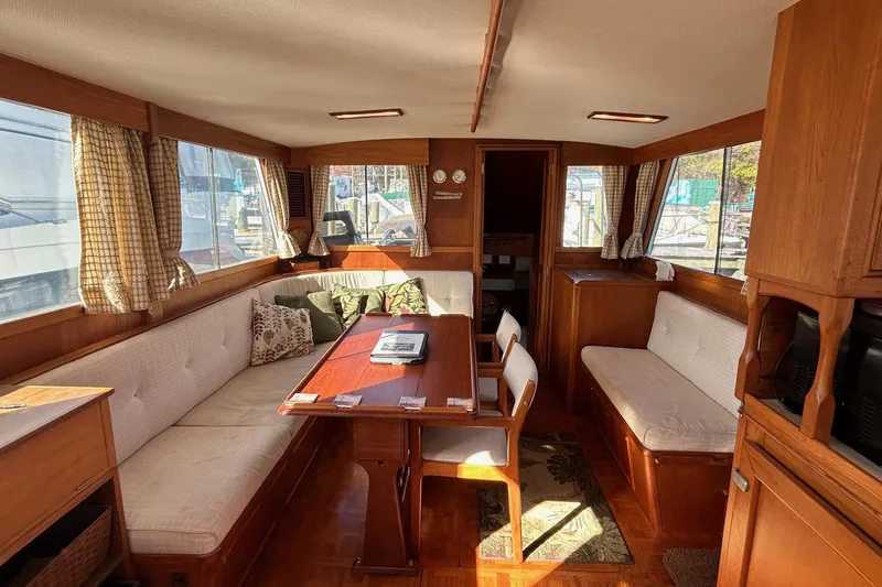 Slide: The Image of Interior of 1986 Grand Banks 42 Classic yacht with cozy seating and wooden furnishings. - 27