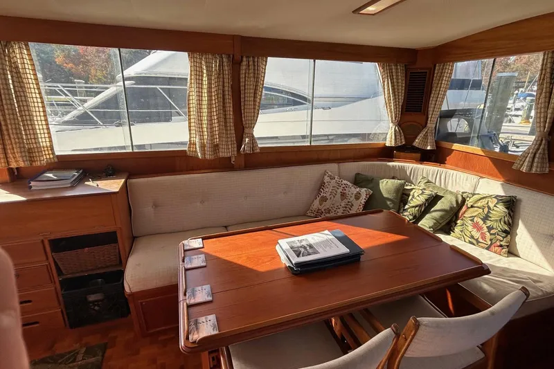 Slide: The Image of Interior of 1986 Grand Banks 42 Classic yacht with cozy seating and wooden table. - 28