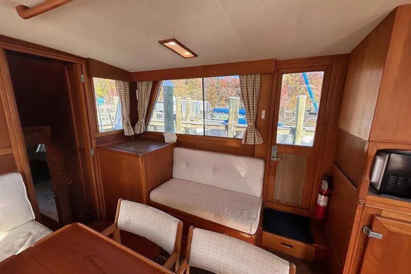 Slide: The Image of Interior of 1986 Grand Banks 42 Classic yacht with wood paneling and seating area. - 29