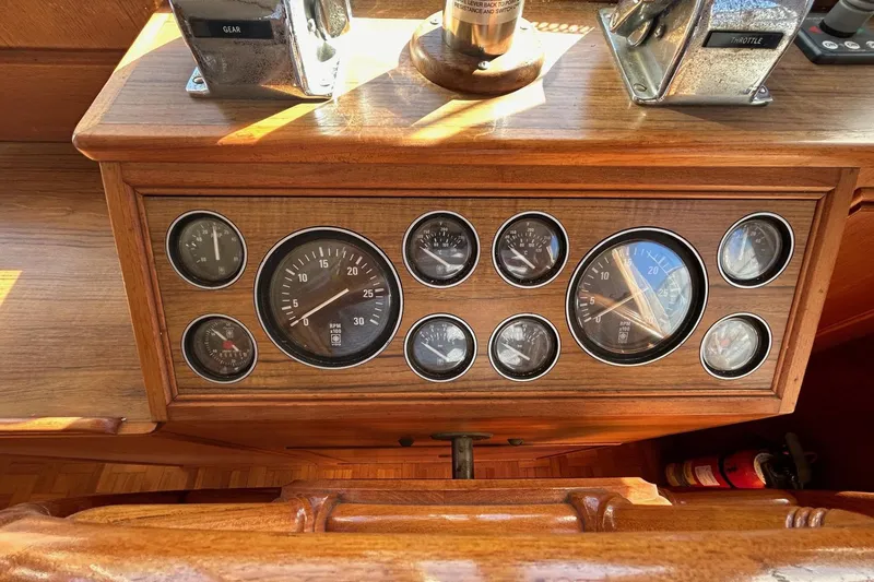 Slide: The Image of 1986 Grand Banks 42 Classic dashboard with gauges and controls in wooden panel. - 32