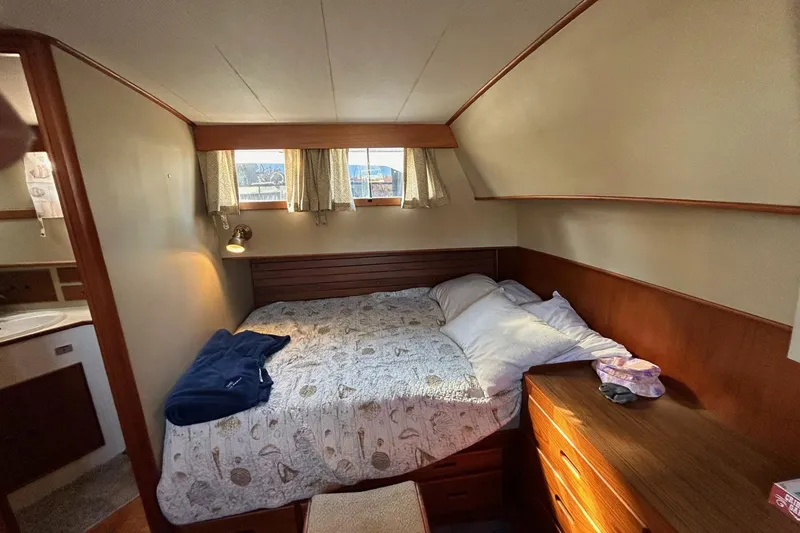 Slide: The Image of Cozy bedroom interior of 1986 Grand Banks 42 Classic yacht with bed and wooden furnishings. - 39