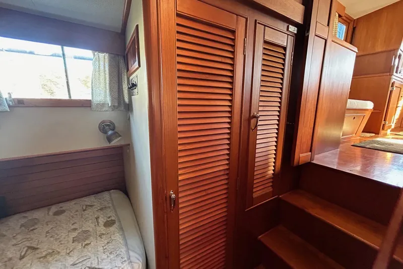 Slide: The Image of 1986 Grand Banks 42 Classic interior with wooden cabinetry and cozy sleeping area. - 41