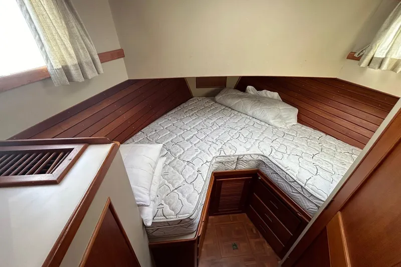 Slide: The Image of Cozy cabin interior of 1986 Grand Banks 42 Classic with wooden accents and bedding. - 44