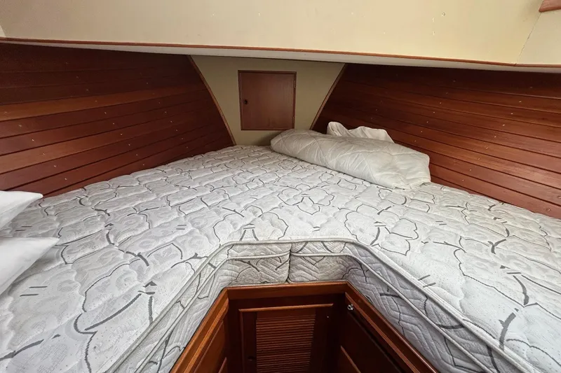 Slide: The Image of Cozy cabin interior of 1986 Grand Banks 42 Classic with wooden paneling and patterned bedding. - 45