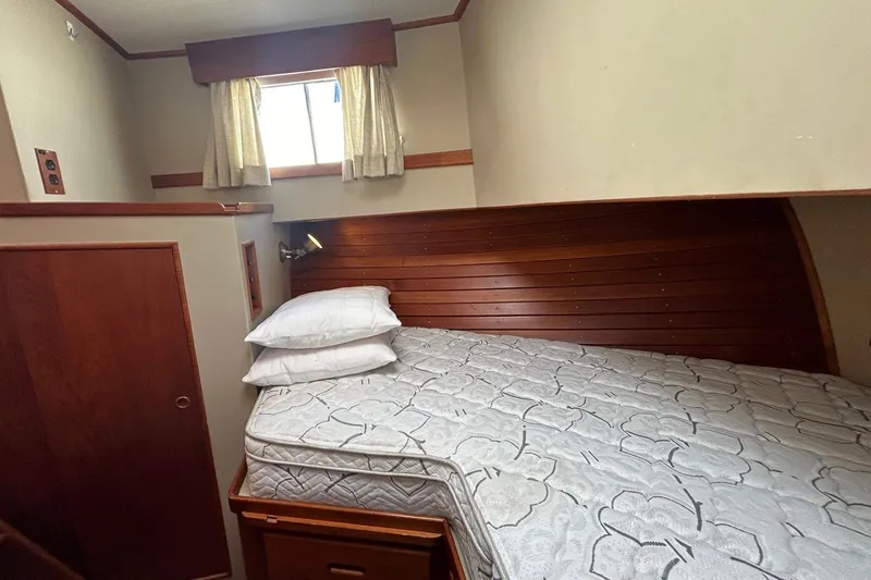Slide: The Image of Cozy cabin bedroom in 1986 Grand Banks 42 Classic yacht with wooden accents. - 47