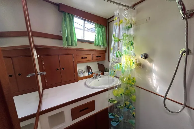 Slide: The Image of Bathroom interior of 1986 Grand Banks 42 Classic yacht with shower and wooden cabinets. - 48