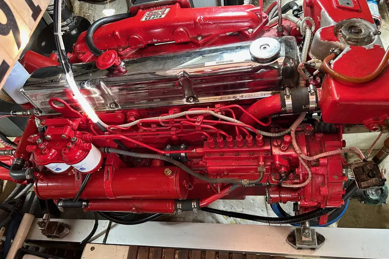 Slide: The Image of Engine of a 1986 Grand Banks 42 Classic, featuring red components and intricate wiring. - 50