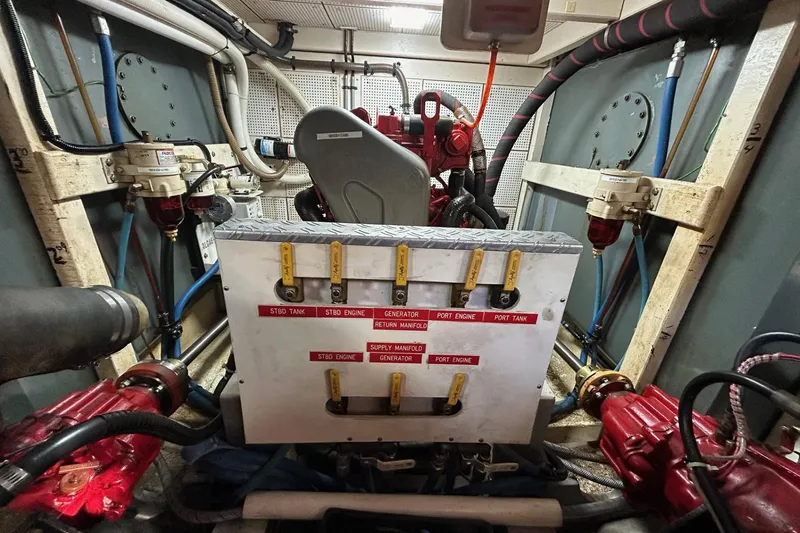 Slide: The Image of Engine room of 1986 Grand Banks 42 Classic with fuel manifold and piping system. - 52