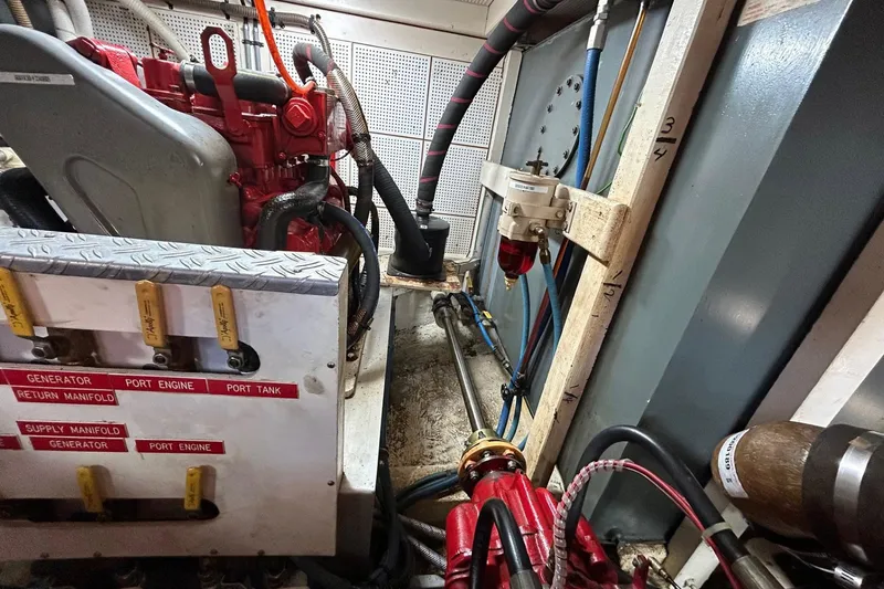 Slide: The Image of Engine room of 1986 Grand Banks 42 Classic, showcasing generator and manifold system. - 54
