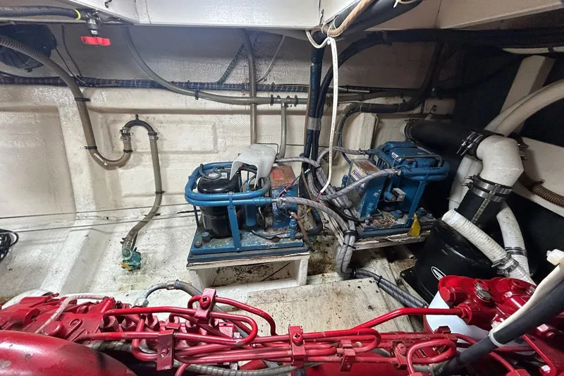 Slide: The Image of Engine room of 1986 Grand Banks 42 Classic yacht with visible machinery and piping. - 55