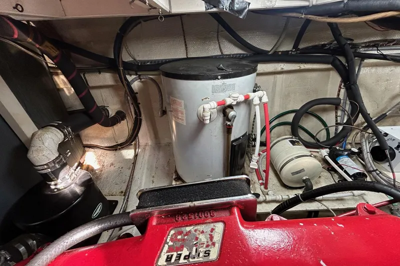 Slide: The Image of Engine room of a 1986 Grand Banks 42 Classic with visible piping and equipment. - 56