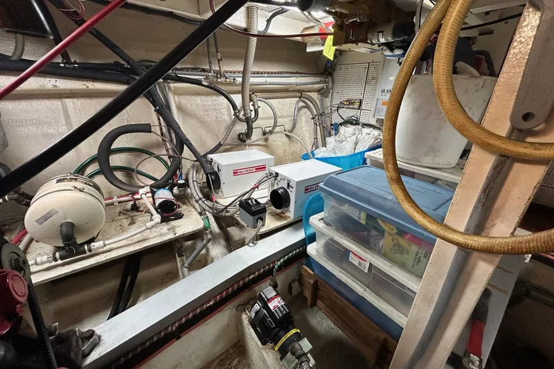 Slide: The Image of Engine room of a 1986 Grand Banks 42 Classic with equipment and storage containers. - 57