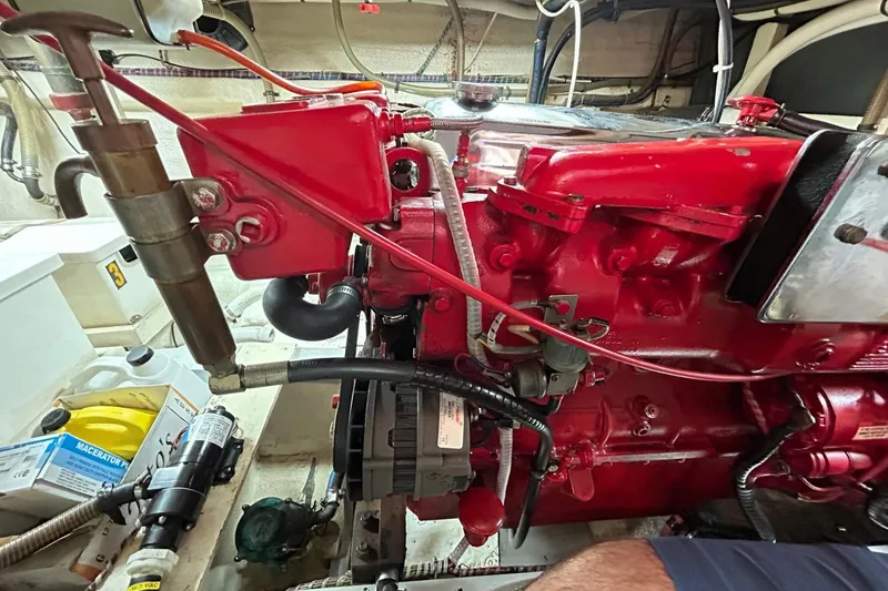 Slide: The Image of Engine room of 1986 Grand Banks 42 Classic with red machinery and various components. - 59