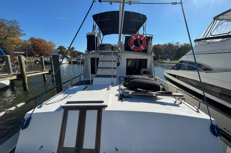 Slide: The Image of 1986 Grand Banks 42 Classic yacht docked, featuring a spacious deck and canopy. - 8