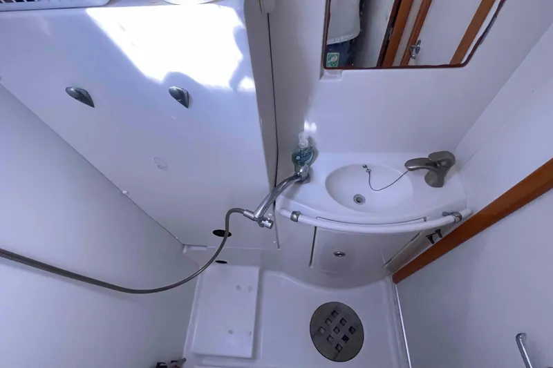 Slide: The Image of Compact bathroom in 2003 Lagoon 410-S2 yacht with sink and shower. - 10
