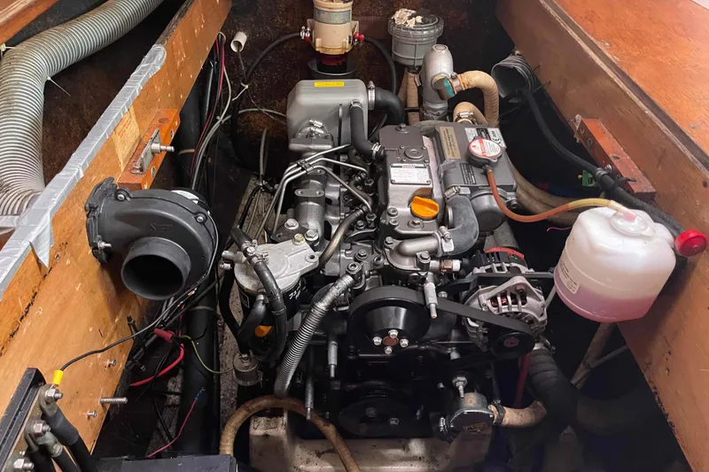 Slide: The Image of Engine compartment of a 2003 Lagoon 410-S2 catamaran, showcasing detailed mechanical components. - 12