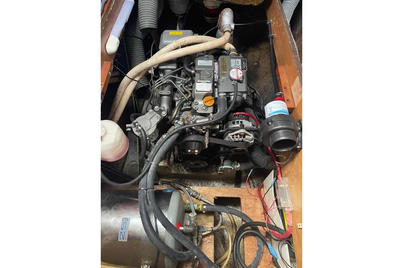 Slide: The Image of Engine compartment of a 2003 Lagoon 410-S2 catamaran, showcasing mechanical components and wiring. - 14