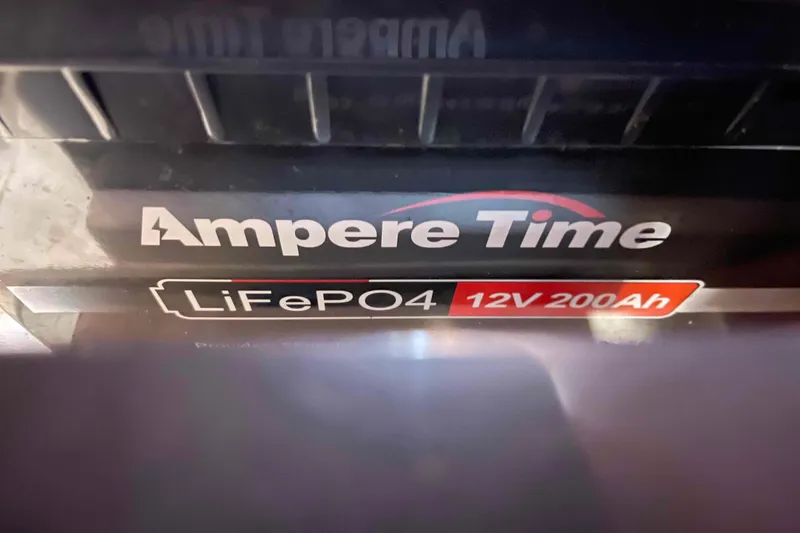 Slide: The Image of Battery compartment of a 2003 Lagoon 410-S2 with connected cables. - 27