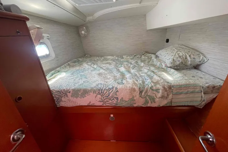 Slide: The Image of Cozy cabin interior of 2003 Lagoon 410-S2 with bed and window. - 3
