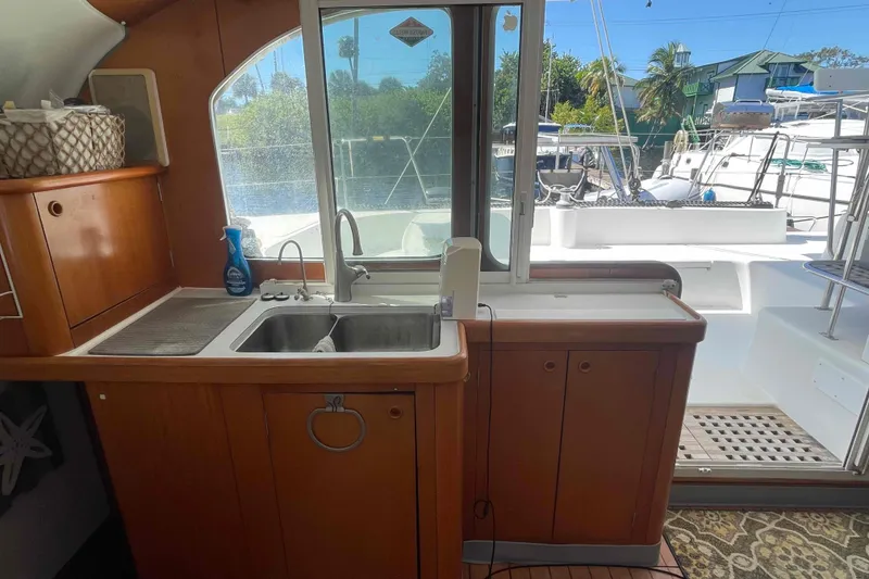 Slide: The Image of Interior of 2003 Lagoon 410-S2 yacht kitchen with open fridge and storage. - 41