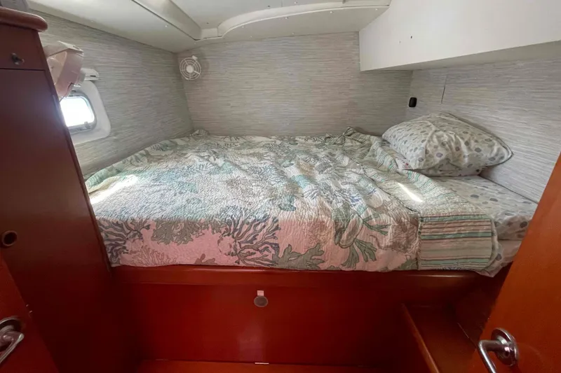 Slide: The Image of Interior view of 2003 Lagoon 410-S2 catamaran kitchen with sink and outdoor access. - 43
