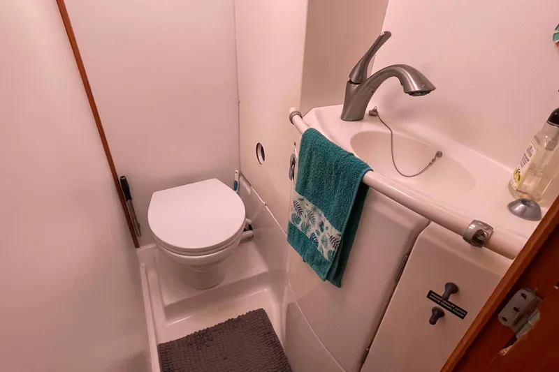 Slide: The Image of Cozy cabin bedroom in 2003 Lagoon 410-S2 yacht with patterned bedding. - 45