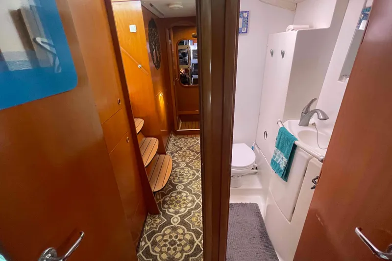 Slide: The Image of Compact bathroom in a 2003 Lagoon 410-S2 yacht with toilet and sink. - 47