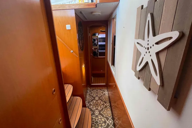 Slide: The Image of Compact bathroom in a 2003 Lagoon 410-S2 yacht, featuring a toilet and sink. - 48