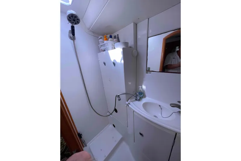 Slide: The Image of Cozy cabin interior of 2003 Lagoon 410-S2 catamaran with patterned bedding. - 56