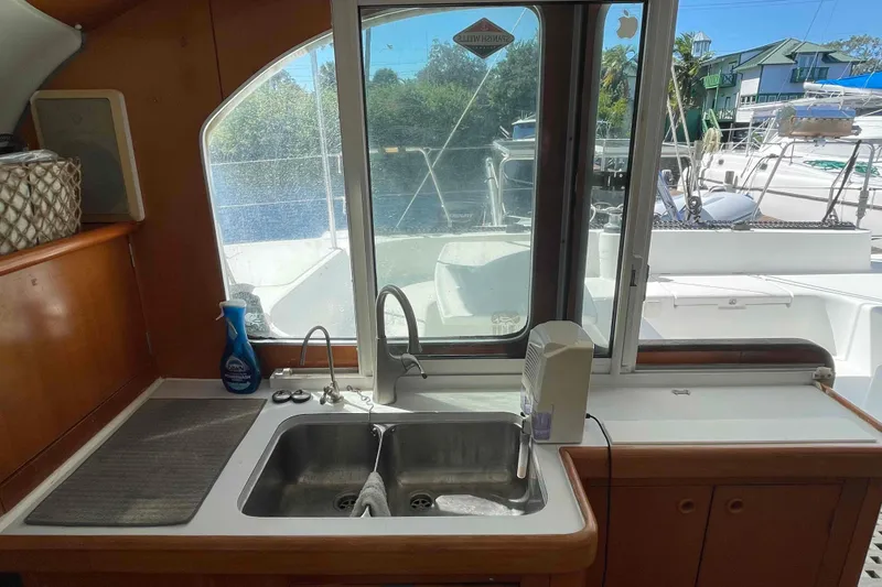 Slide: The Image of Bathroom interior of 2003 Lagoon 410-S2 yacht with shower and sink. - 58