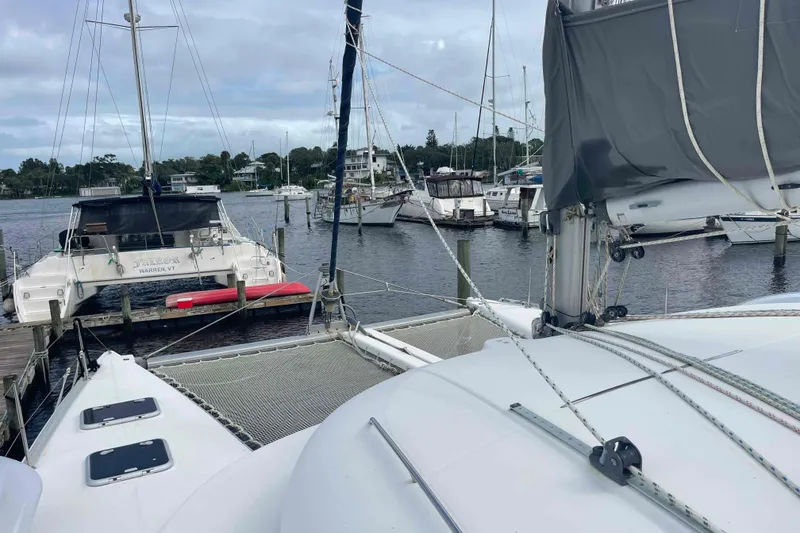 Slide: The Image of Interior of 2003 Lagoon 410-S2 catamaran with cozy seating and nautical decor. - 59