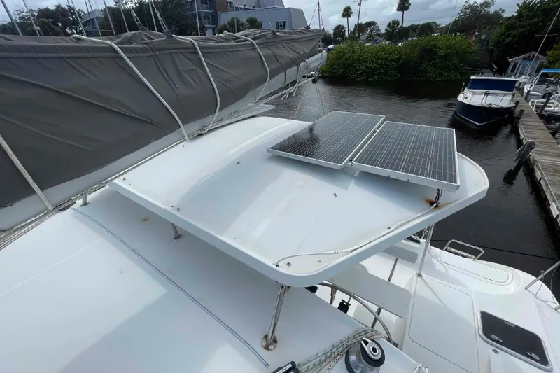 Slide: The Image of Interior view of a 2003 Lagoon 410-S2 catamaran kitchen with sink and window. - 60