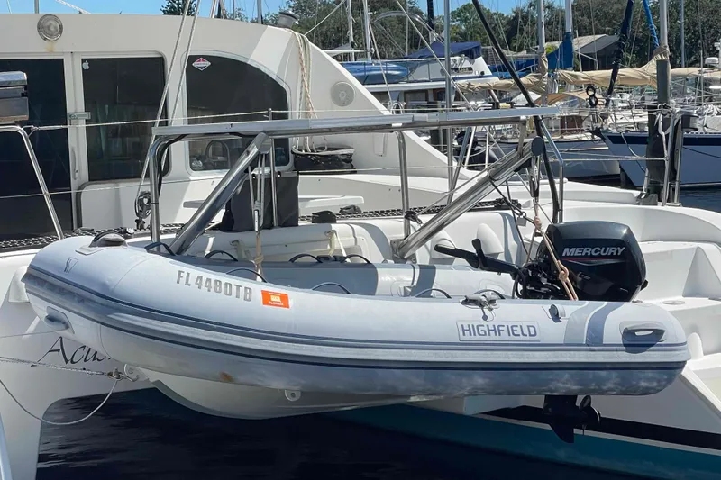 Slide: The Image of 2003 Lagoon 410-S2 catamaran with solar panels docked at marina. - 62