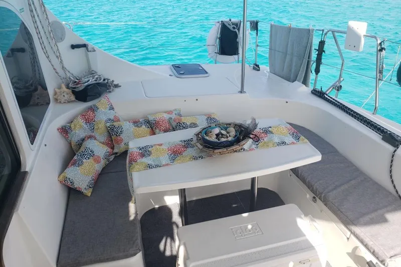 Slide: The Image of 2003 Lagoon 410-S2 catamaran docked, showcasing sleek white hull design. - 77