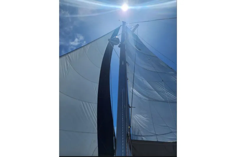 Slide: The Image of Sailing catamaran Lagoon 410-S2, 2003 model, on clear turquoise water under blue sky. - 83