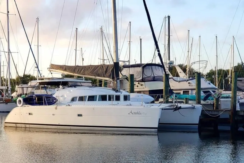 Slide: The Image of Sailing yacht Lagoon 410-S2, 2003 model, with sunlit sails against a clear blue sky. - 85