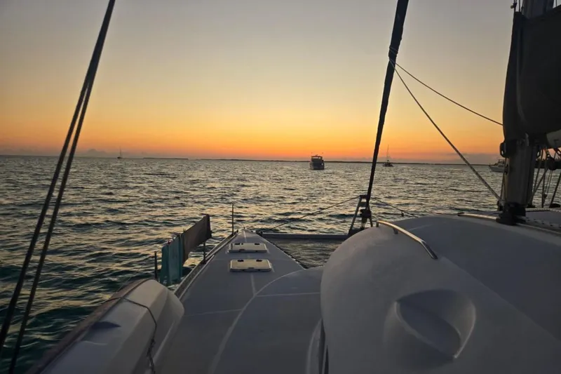 Slide: The Image of Sunset view from a 2003 Lagoon 410-S2 catamaran on the ocean. - 89