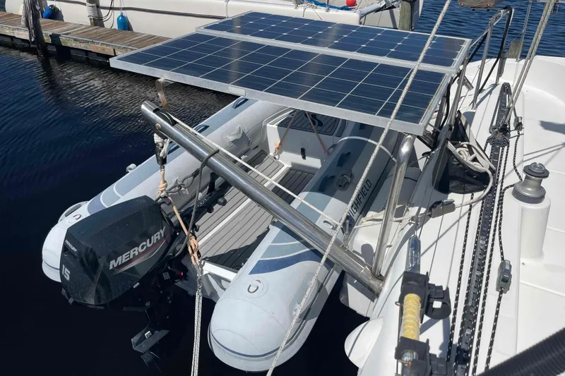 Slide: The Image of Lagoon 410-S2 catamaran with solar panels and dinghy, docked at marina, 2003 model. - 20