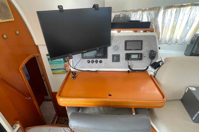 Slide: The Image of Interior of 2003 Lagoon 410-S2 catamaran with seating, table, and navigation station. - 31