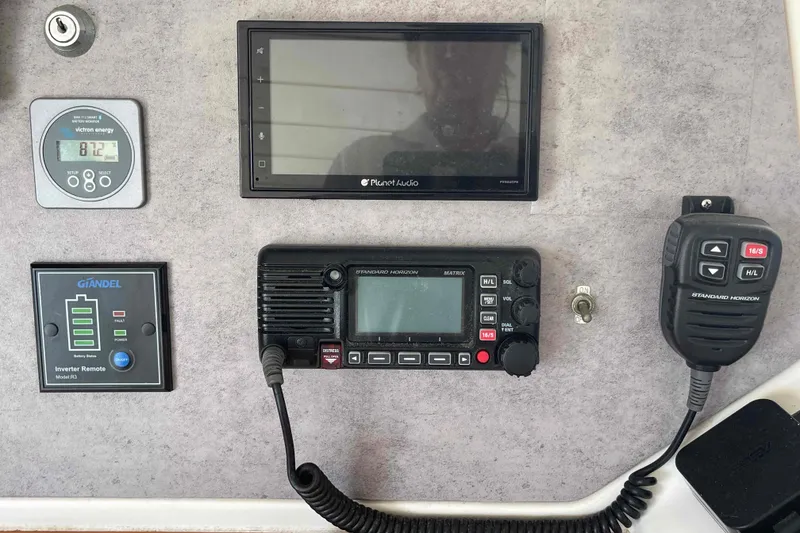 Slide: The Image of Navigation station in 2003 Lagoon 410-S2 catamaran with monitor and communication equipment. - 32