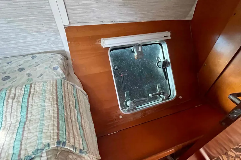 Slide: The Image of Lagoon 410-S2 2003 yacht kitchen with wooden cabinets and sink, marina view. - 44